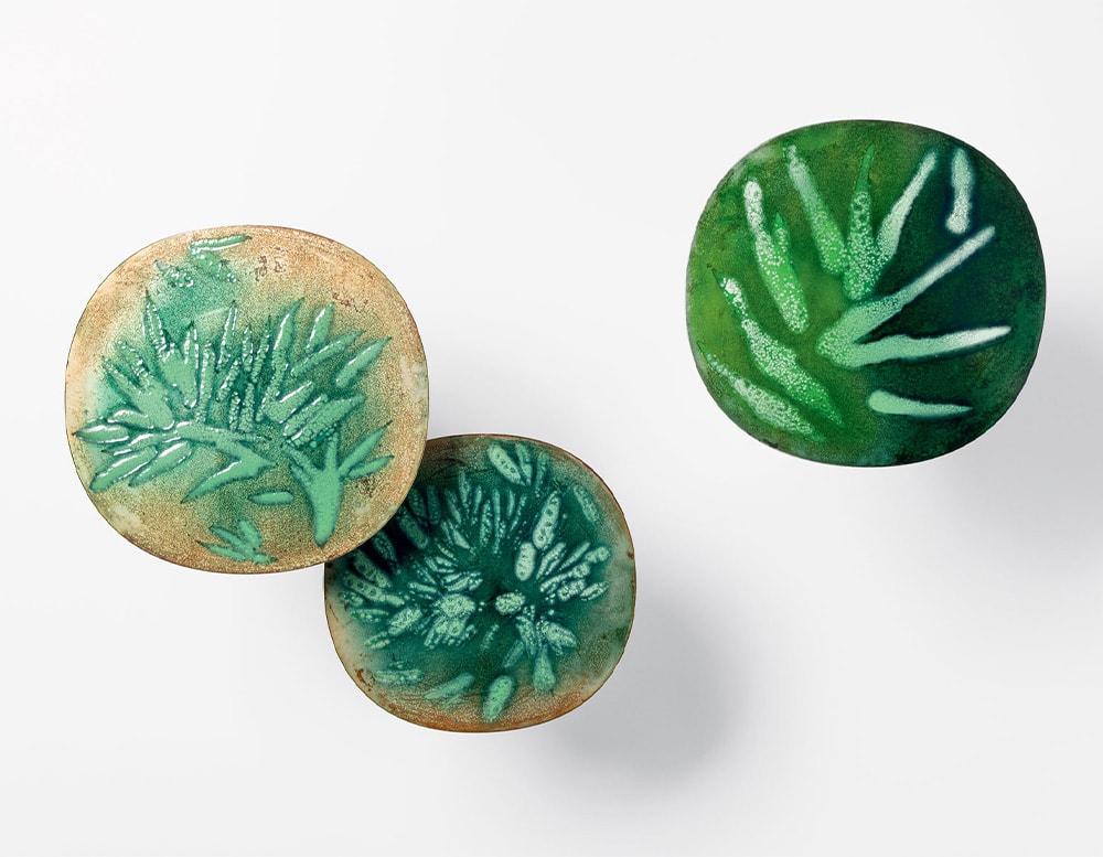Three side tables seen from above with green textured tops