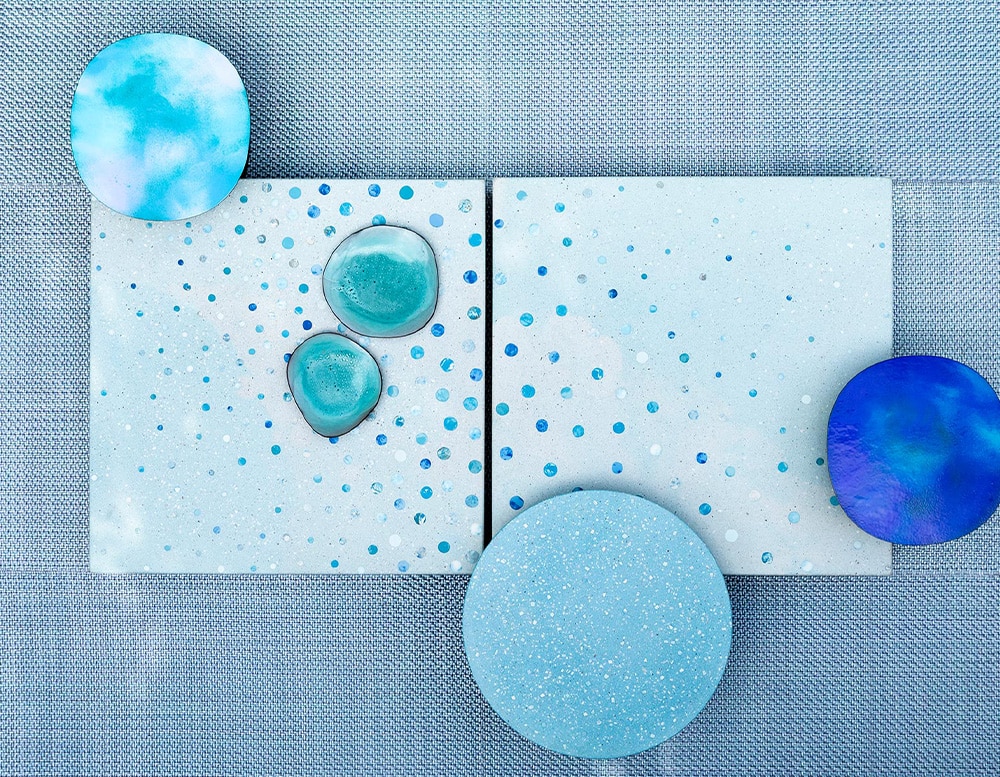 Three side tables seen from above with tops in different shades of blue