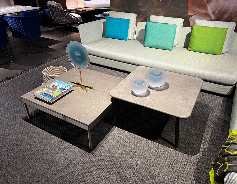 coffee-colored side tables made of wood and farsena stone tops.