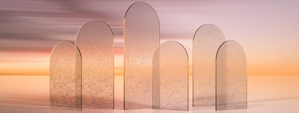 A collection of translucent arched glass panels set against a glowing sunset, casting soft reflections in a serene, pastel-hued setting