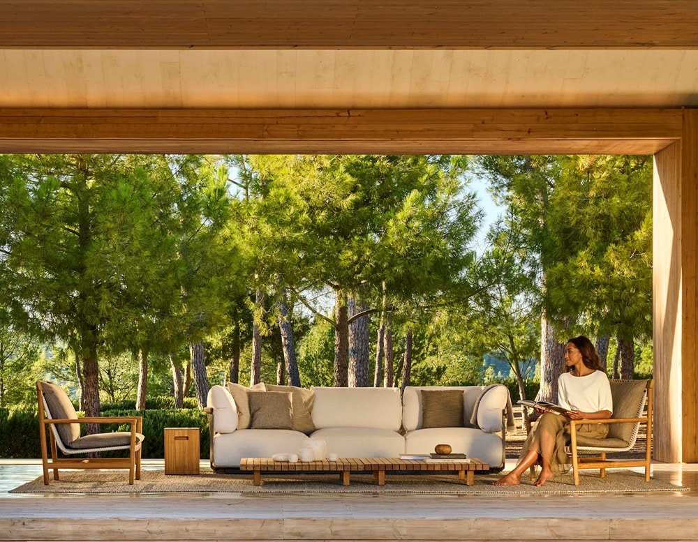 hand-woven chairs with their cushions in different shades of gray and white and brown wooden bases in a living room