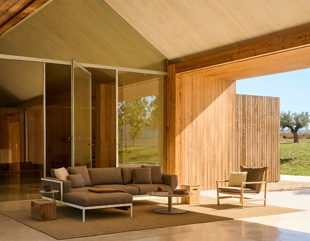 hand-woven chairs with their cushions in different shades of gray and white and brown wooden bases in a living room