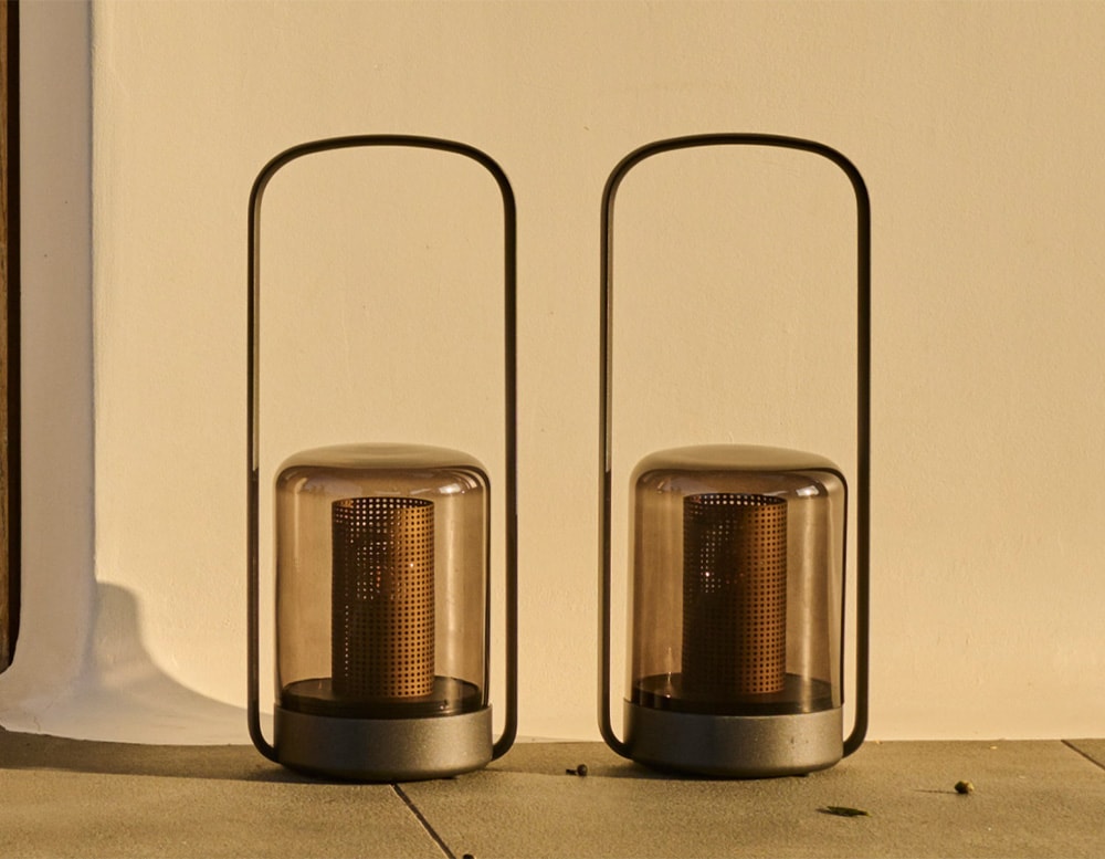 portable lamps made of black glass and black aluminum of the same size in an outside