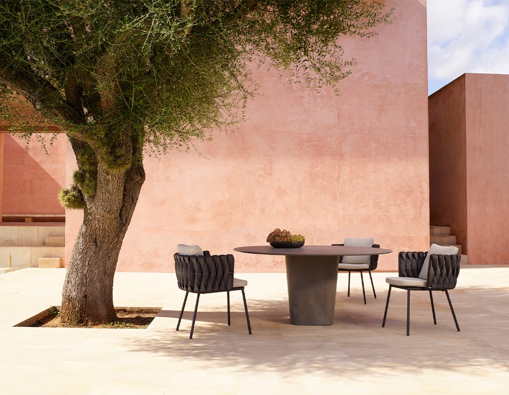 dining room made of lava stone in a dark gray tone in the shape of an oval