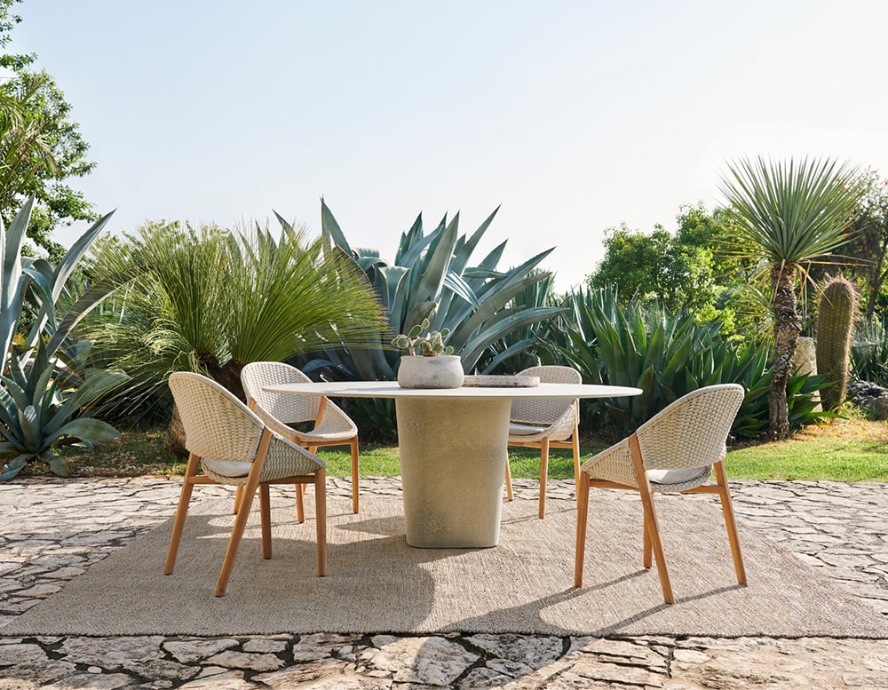 dining table made with stone in a dark gray tone in oval shape