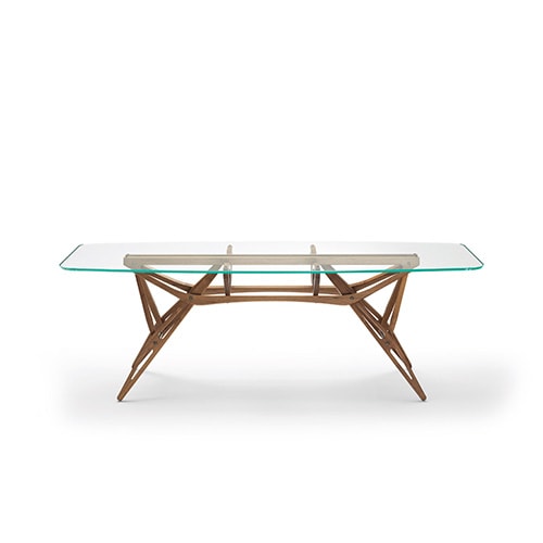 dining table made of thin brown wood and top in thick transparent glass on a white background