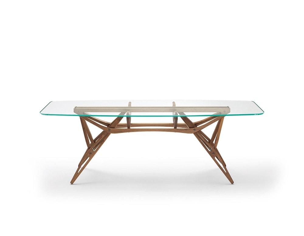 dining table made of thin brown wood and top in thick transparent glass on a white background