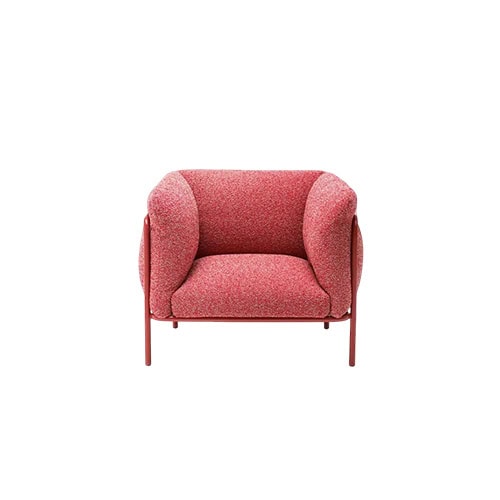 Soft pink armchair with rounded cushions supported by a sleek metal frame combining comfort and style for modern interiors.