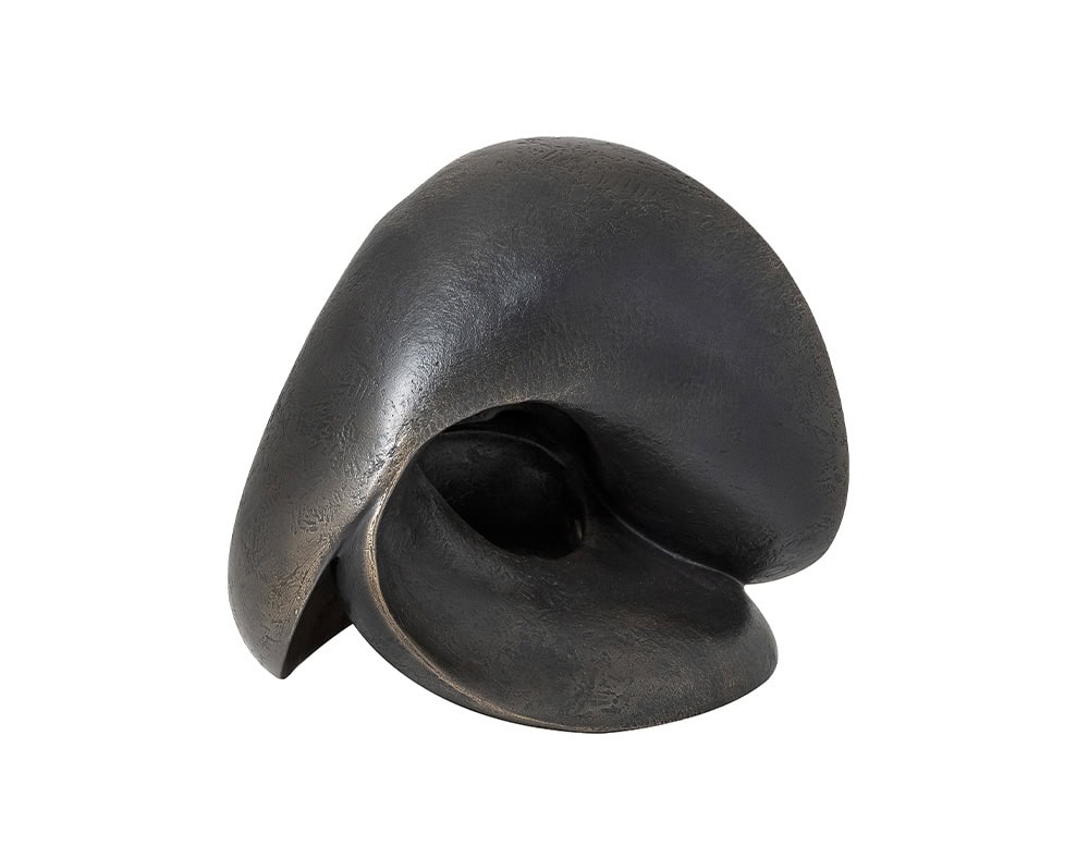 Bronze accessory with fluid, organic curves forming an abstract sculptural piece. Its textured surface and flowing design create a striking decorative object with timeless artistic presence.