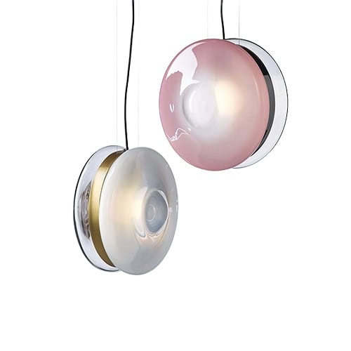 Two pendant lights with smooth glass domes in soft white and blush pink tones hang side by side, featuring metallic accents that add a touch of elegance and modern charm.