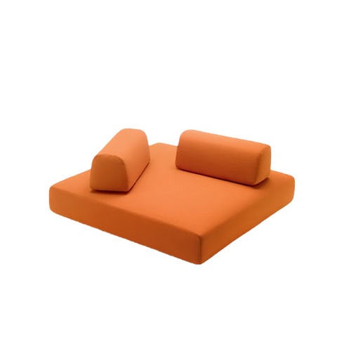 Contemporary outdoor ottoman featuring a bold color and modular bolsters, designed for versatile comfort and style in open-air environments.