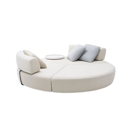 Circular outdoor sofa with modular seating and integrated table, offering comfort and versatility for modern lounging in open-air spaces.