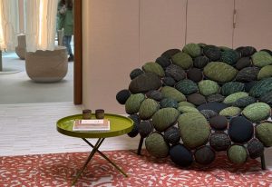 Boa captivates with its nest-like cluster of green, olive, and charcoal upholstered cushions. Its organic, boulder-inspired form turns seating into a sculptural experience that’s cozy, inviting, and utterly unique.
