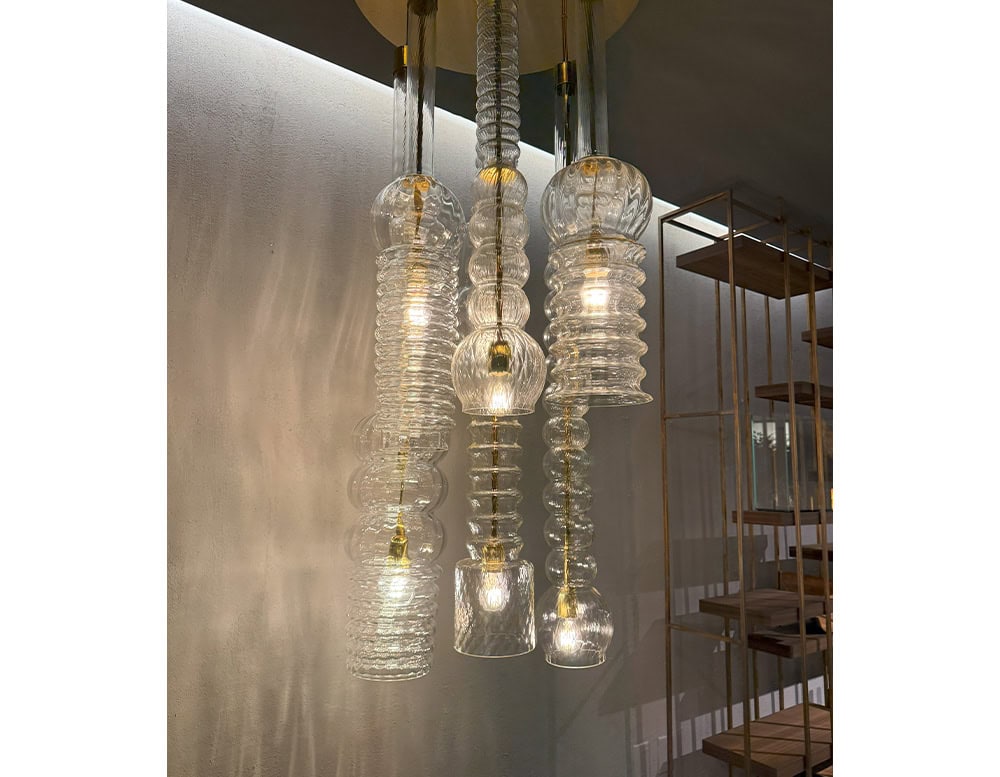 Praha Suspension Light creates a dramatic statement with hand-blown glass pendants in sculptural forms. The soft glow and textural interplay add warmth and sophistication to contemporary interiors.