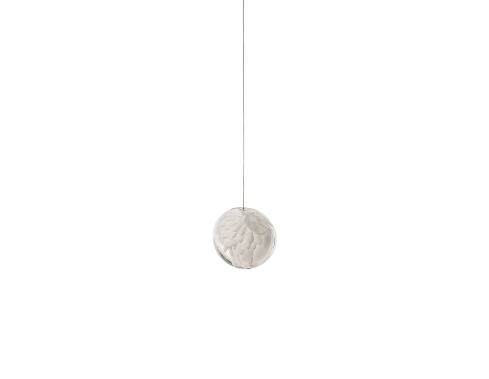 The Boc 118 Series single pendant highlights a hand-blown glass sphere with delicate texture, suspended by a fine cable to create a minimal and luminous focal point.