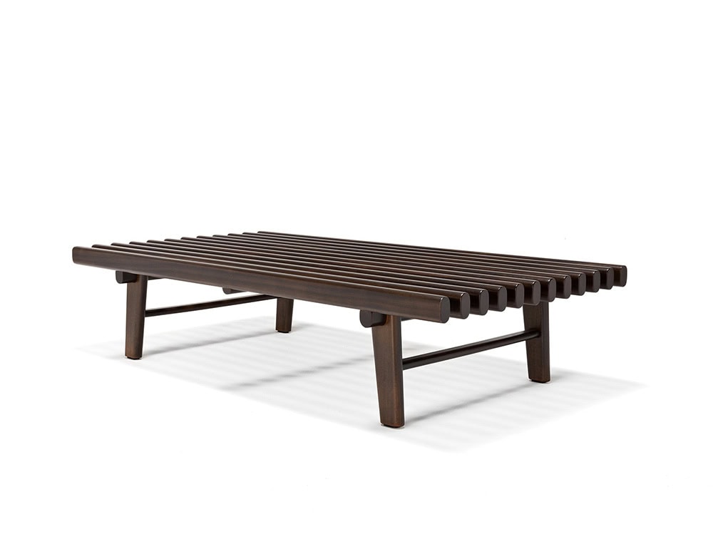 The Ext Elba Coffee Table Outdoor features a bold slatted wood surface with rounded edges and a solid base, offering a contemporary yet timeless design for open-air lounging spaces.