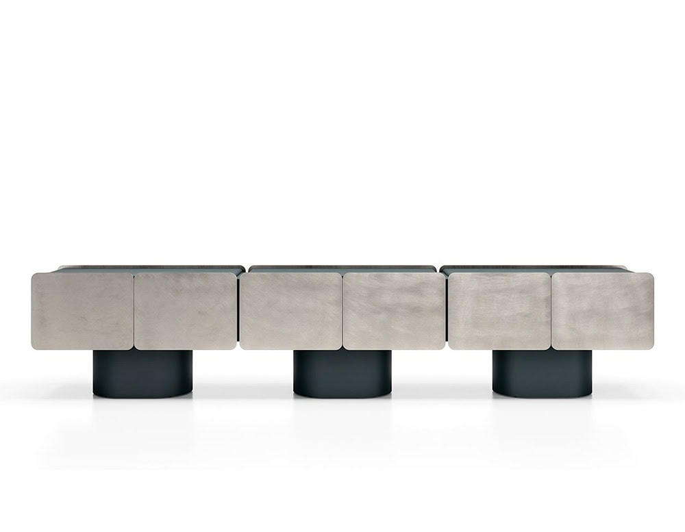 GR Admira Cabinet in brushed silver with deep charcoal cylindrical bases, creating bold contrast between the metallic surface and dark foundation.