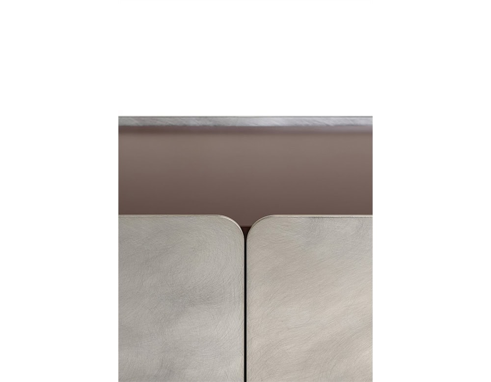 Close-up of the GR Admira Cabinet's brushed metallic doors paired with a muted burgundy frame for a refined, contrasting finish.