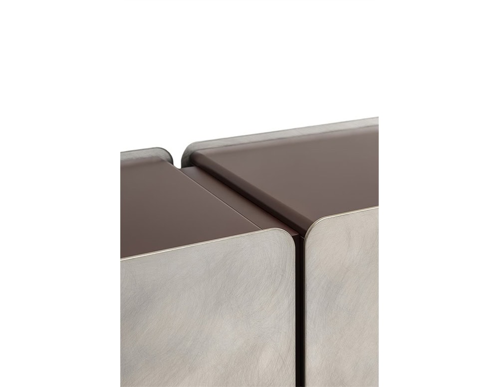 Close-up of the GR Admira Cabinet, highlighting the brushed metal doors and brown lacquered top with precise alignment and smooth rounded edges.