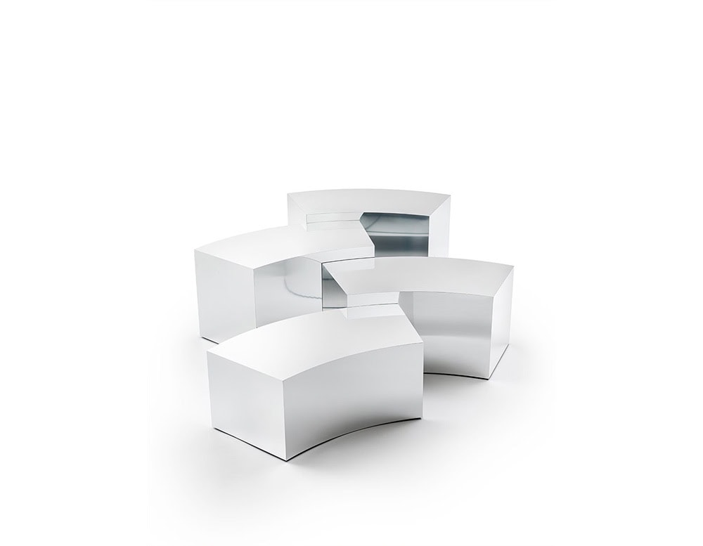 The GR Arch Coffee Table features a modular arrangement of smooth, curved volumes. Its sleek surface offers a silvery mirror finish, adding a subtle cool-toned shimmer that reflects its surroundings.