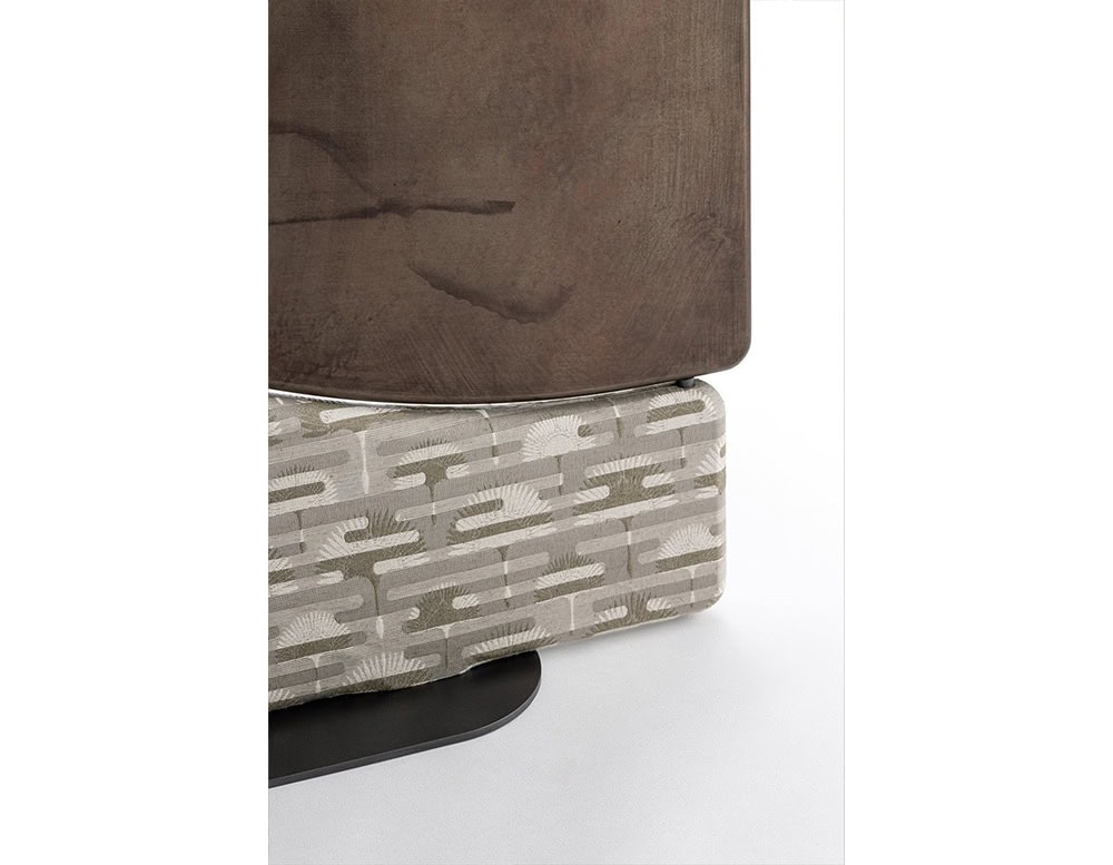 The Enso Screen detail shows the soft grey pattern fabric paired with a matte brown wooden accent. The mix of textures adds subtle depth while maintaining a neutral palette.