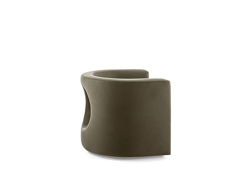 The GR H2O Lounge Chair presents a continuous, curved silhouette with a sculptural cut-out along the back. Its understated earth-toned upholstery adds a neutral, soft visual texture.