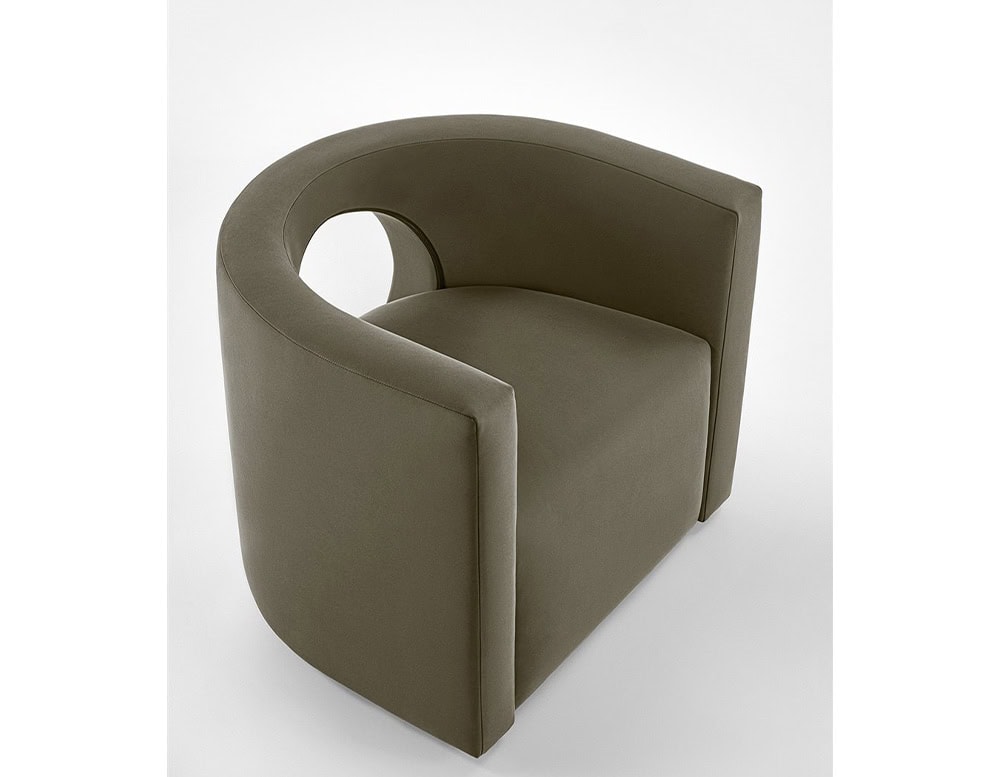The GR H2O Lounge Chair features a distinctive circular back cut-out and a softly upholstered frame. Its muted tone complements the chair's smooth, continuous form.