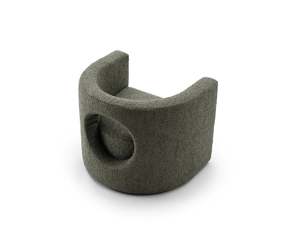 The GR H2O Lounge Chair highlights its circular back cut-out and soft textured fabric. Its earthy tone complements the chair’s sculptural, wraparound silhouette.