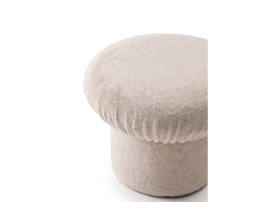 GR Nala Stool in pale beige fabric, set against a clean white background. Its rounded cushioned top and soft texture give it a plush, cozy appearance.