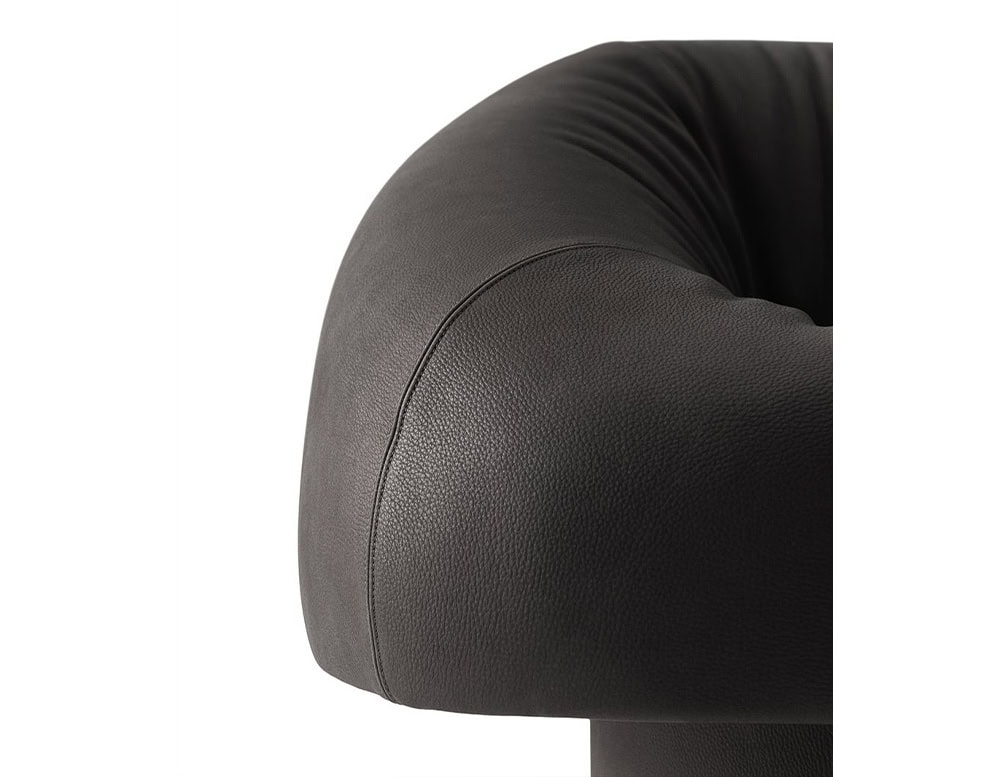 The GR Olivia Chair highlights its refined craftsmanship in this close-up, showcasing the supple leather texture and the precise, sculptural curves of its generously padded form.
