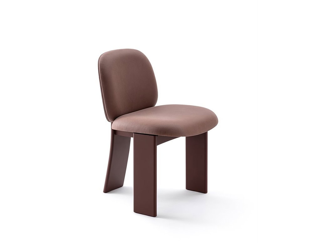 The GR Saki Chair presents a harmonious blend of soft mauve upholstery and rich brown lacquered wood legs. Its curved silhouette and plush seat offer comfort, while the solid structure provides a refined, architectural statement.