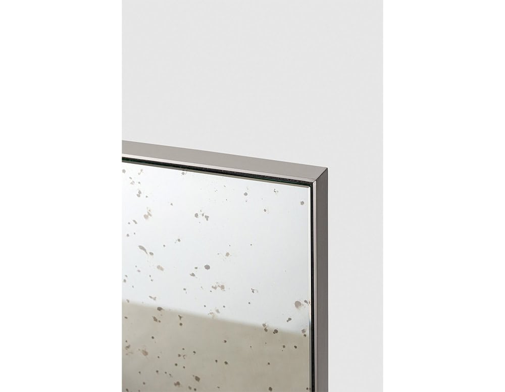The GR Stresa Mirror features a finely detailed antiqued surface, framed in a slim, bronze-toned metal edge. Its softly speckled texture brings a refined, vintage character to contemporary interiors.