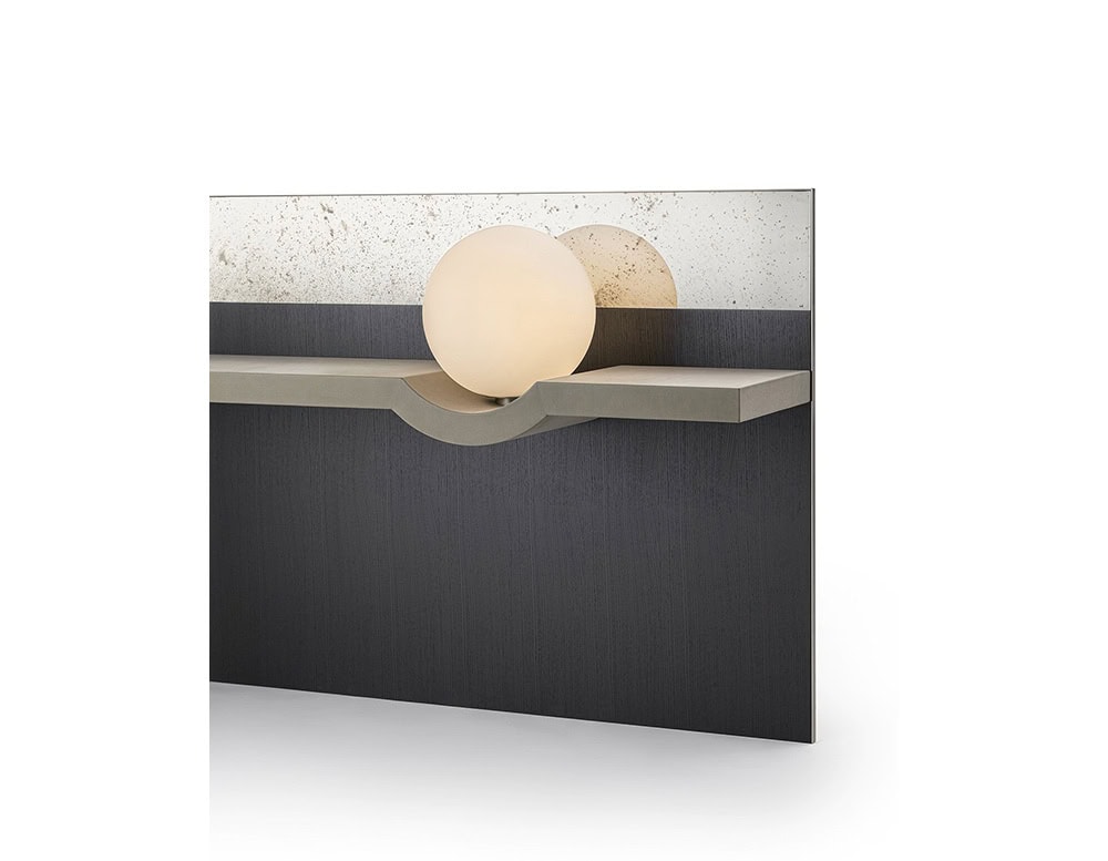 he GR Stresa Mirror combines a smoky mirrored surface with a sculptural shelf detail. An opaline sphere light subtly reflects against the textured glass, adding a soft glow to the composition.