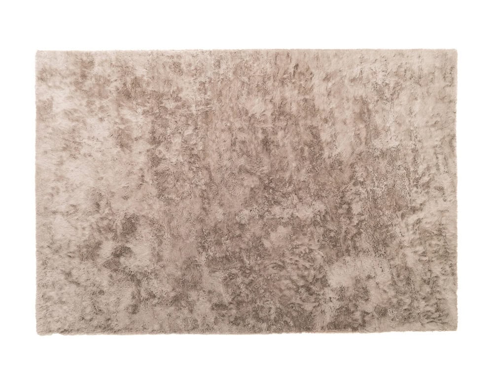 The Kymo Urban Soul Rug in taupe features a dense, shimmering pile that creates subtle variations in tone, adding depth and a luxurious touch to contemporary interiors.