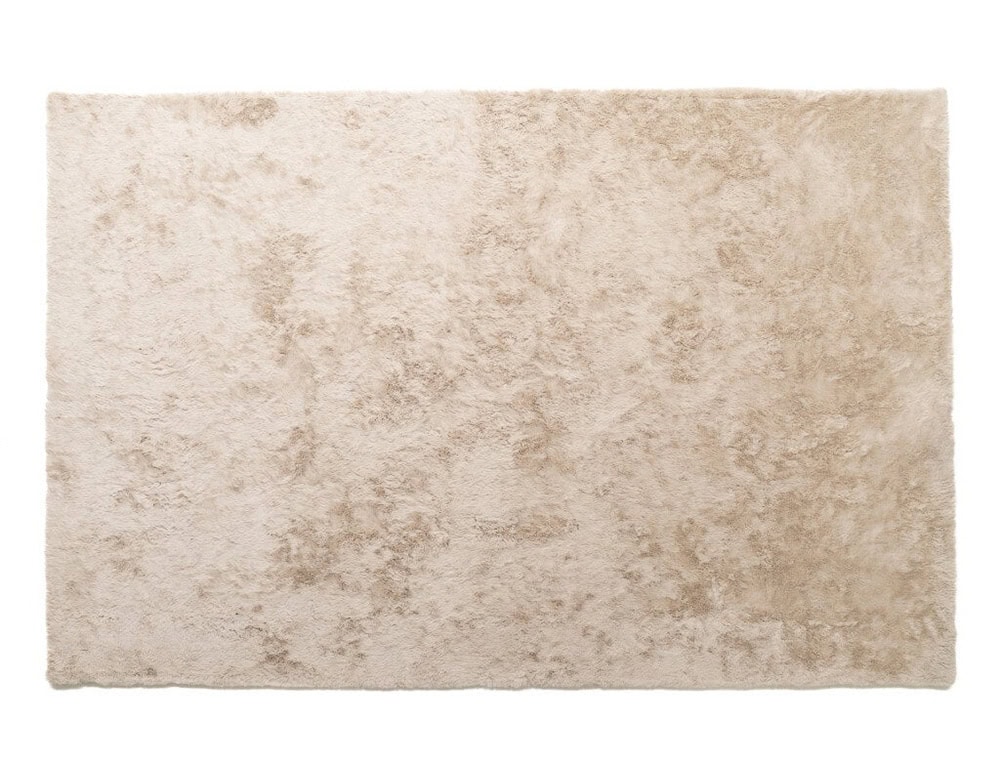The Kymo Urban Soul Rug in beige offers a soft, plush texture with a lustrous finish that reflects light beautifully, creating a warm and inviting atmosphere in any space.