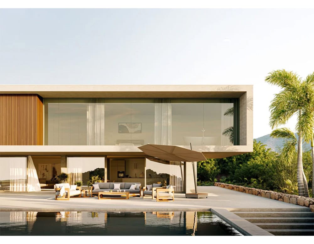 Versa UX Umbrella stands in warm taupe beside a modern villa, shaded by palms and facing a serene pool. Its clean angles and soft neutral tone echo the architecture and blend seamlessly with the lush outdoor setting.