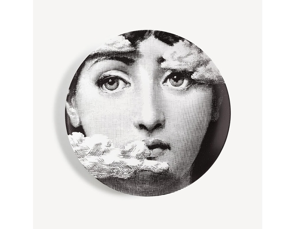 A surreal porcelain plate featuring a monochrome female face partially obscured by drifting clouds. The ethereal imagery creates a poetic blend of portraiture and dreamlike atmosphere, ideal as a decorative accent or collector’s piece.