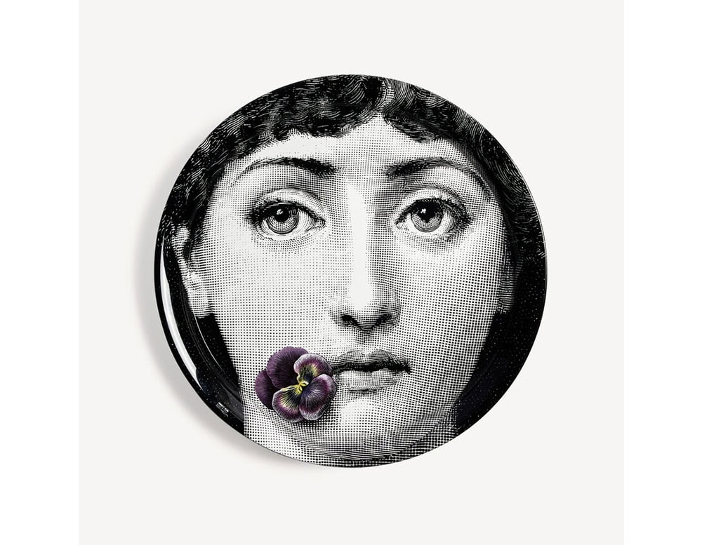 Monochrome portrait tray with a dramatic expression and a vivid violet flower delicately placed on the lips. A poetic blend of classic beauty and modern surrealism.