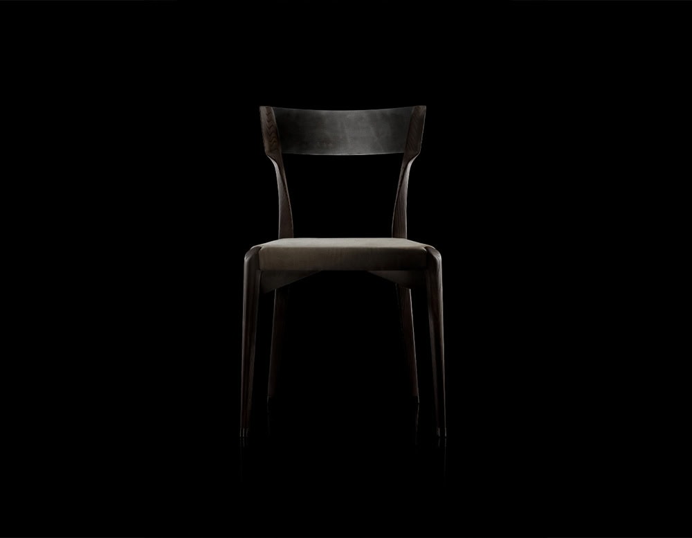 The Hen Chair VA features a sculpted wood frame with a curved backrest and a gently upholstered seat. Its silhouette strikes a refined balance of strength and elegance, ideal for modern or classic interiors alike.