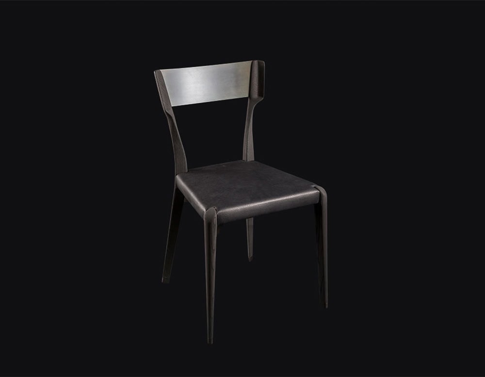 The Hen Chair VA presents a sleek profile with a sculpted wood backrest and a flat leather seat. Its minimalist design and clean silhouette make it an ideal piece for refined modern spaces.