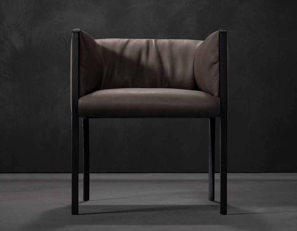 The Hen Shelly Chair features plush leather upholstery cradled by a clean vertical frame, merging refined comfort with an architectural presence.