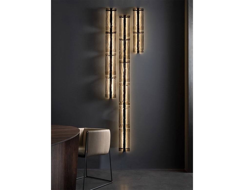 This Hen Vibe Wall Light features vertical handblown glass tubes in a smoked amber finish. Its sculptural rhythm brings warm ambient lighting and artistic depth to modern interiors.