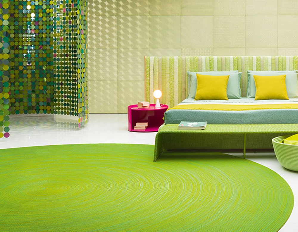 Round green outdoor rug with subtle swirl texture. Sets a vibrant tone and pairs seamlessly with playful, colorful furnishings.