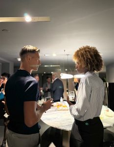 A lively exchange unfolds as attendees enjoy the evening ambiance.