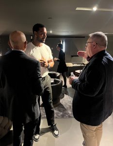 Guests gather for a lively conversation, exchanging ideas and insights.