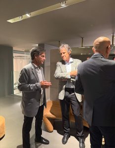 Guests engage in a quiet, thoughtful exchange during the gathering.