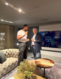 An engaging conversation unfolds as two guests share insights in a cozy lounge setting.