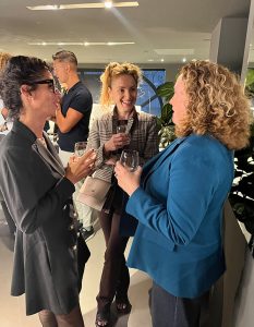 Attendees connect and engage in warm, friendly dialogue during the event.