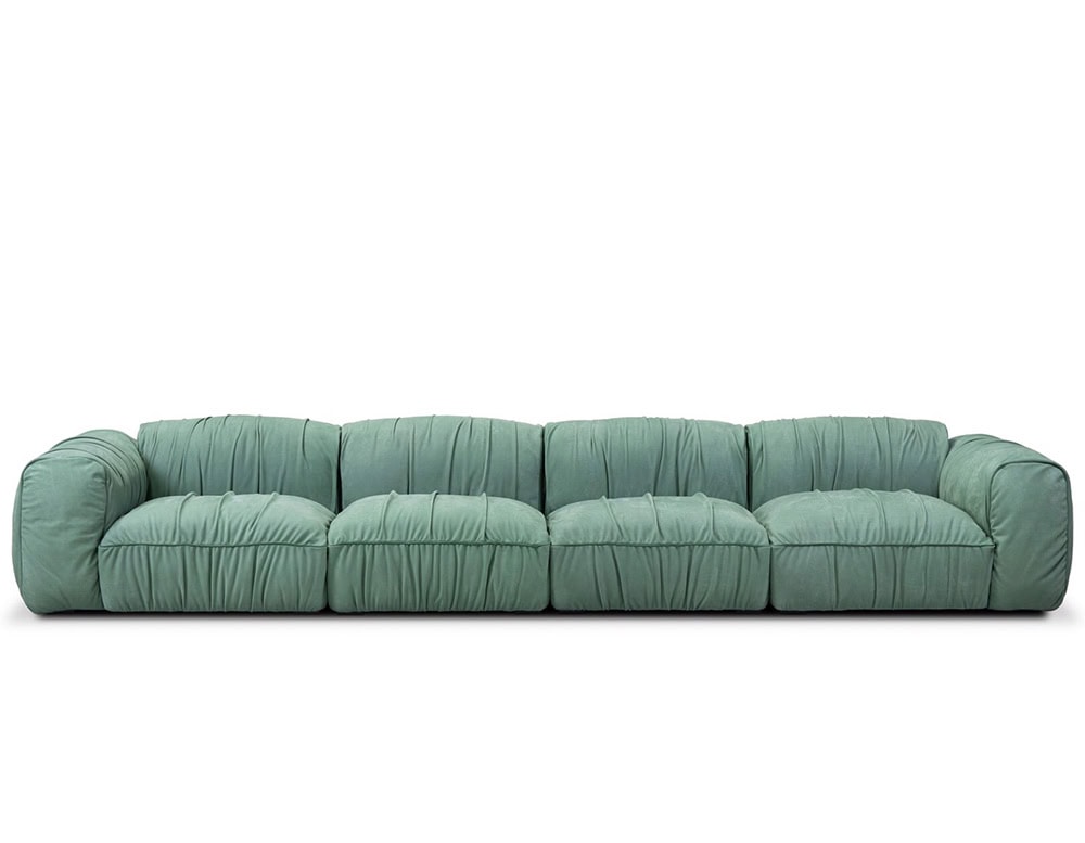 Contemporary green sofa with five spacious seats and gathered fabric details, featuring a relaxed silhouette that highlights its plush and inviting design.