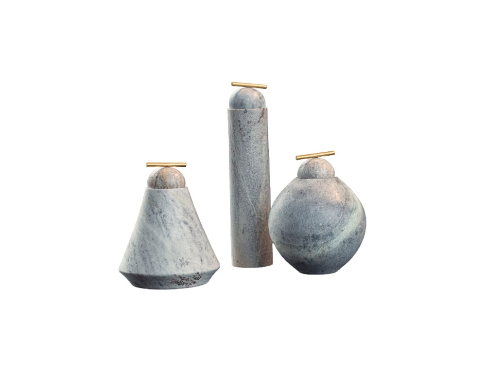 AOI Vase collection features sculptural stone forms in soft gray tones, each crowned with a brass accent that blends natural texture with refined design.